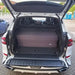 Weißer BMW X5 mit geöffneter Heckklappe, gefaltete Matratze aus orthopädischem Kaltschaum im Kofferraum, made in Germany, Manufaktur seit 2002.